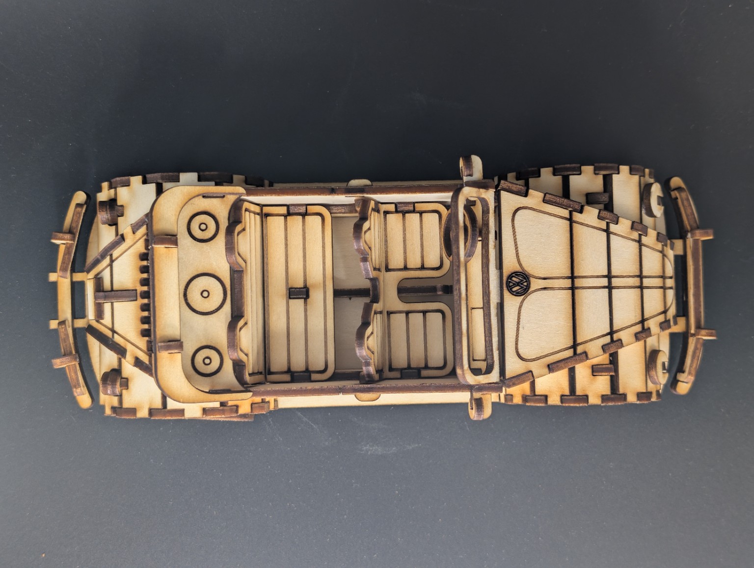 Close-up overhead view of a laser-cut wooden classic convertible model